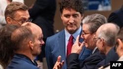 British Prime Minister Keir Starmer (R) speaks with Canadian Prime Minister Justin Trudeau (C) and German Chancellor Olaf Scholz (L) at the NATO summit in Washington on July 10, 2024.