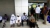 FILE - People wait outside currency exchange bureau in Khartoum, Sudan February 28, 2021. 