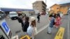Tourists gather in front of the Lawson convenience store, a popular photo spot framing a picturesque view of Mt. Fuji in the background on cloudy evening of Tuesday, April 30, 2024, at Fujikawaguchiko town, central Japan.