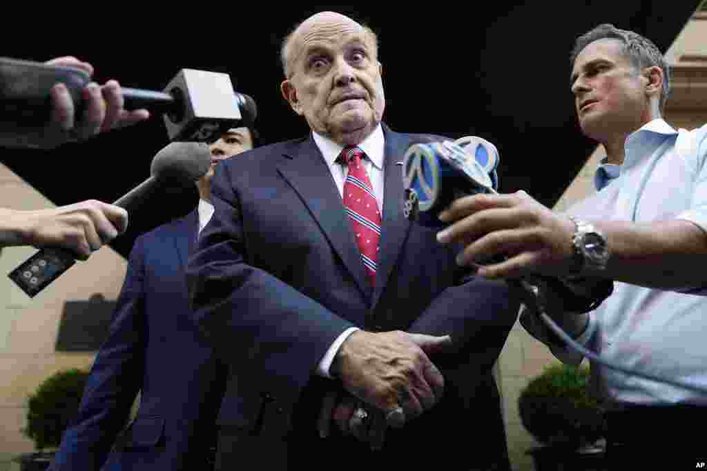 Former Mayor of New York Rudy Giuliani speaks to reporters as he leaves his apartment building in New York.