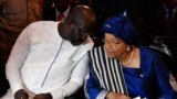 FILE - Liberia's president-elect George Weah (L) listens to the country's outgoing president Ellen Johnson Sirleaf during a church service at the centennial memorial pavilion in Monrovia on January 21, 2018. 