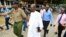 Detectives escort Ezekiel Ombok Odero, head of New Life Prayer Centre and Church in Kilifi County, at the police headquarters for investigations into deaths linked to another Christian cult, in Mombassa, Kenya, April 27, 2023.