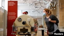 FILE - A staff member poses next to an iron lung in the Science Museum during a Guest Preview Day ahead of the official opening in London, Aug. 17, 2020. Paul Alexander of Dallas, Texas, a polio survivor knows as the "man in the iron lung" died aged 78 on March 12, 2024.