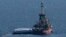 Kapal milik kelompok bantuan Open Arms dengan bantuan di platform mengangkut sekitar 200 ton beras dan tepung langsung ke Gaza, berangkat dari pelabuhan dari selatan kota Larnaca, Siprus, Selasa, 12 Maret 2024. (AP/Petros Karadjias)