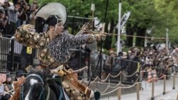 An archer in ancient samurai warrior uniform riding on a horse shoots an arrow to a target during a Yabusame horseback archery demonstration of the samurai martial arts at Sumida Park in Tokyo, April 20, 2024. 
