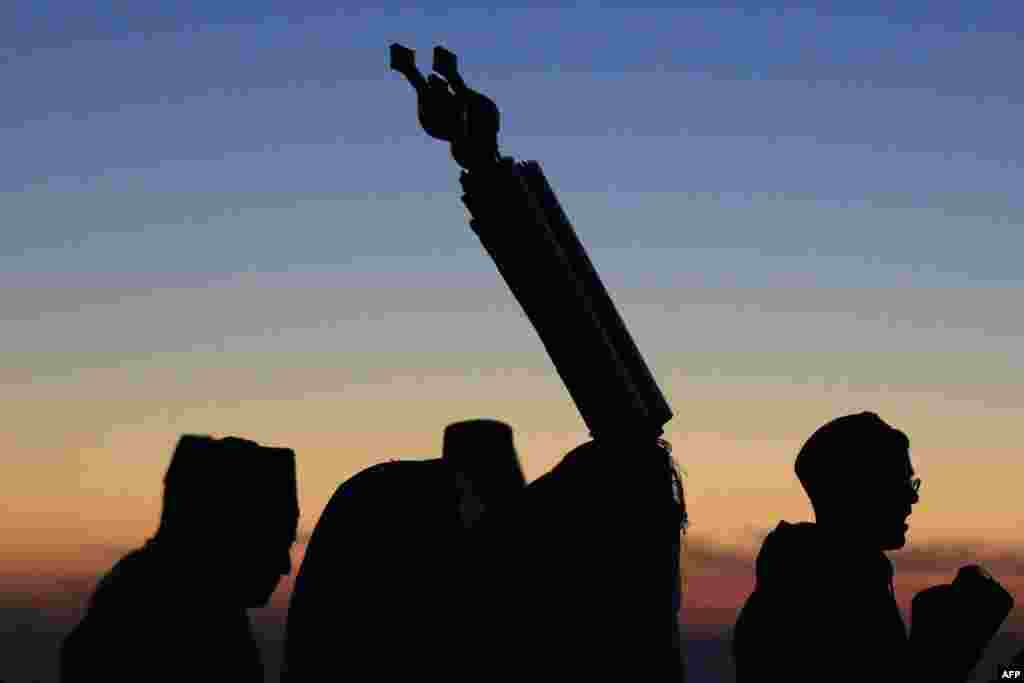 Samaritan worshipers gather at dawn to pray on top of Mount Gerizim, near the northern West Bank city of Nablus, during celebrations of Passover according to their tradition.