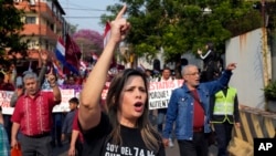 Kattya González, a popular senator and vocal government critic who was booted from the Senate in February, marches in an opposition rally, marking a year since President Santiago Pena's inauguration, in Asuncion, Paraguay, Aug. 15, 2024.