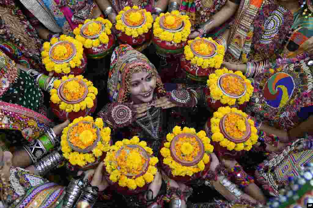 Indians in traditional attire practice the Garba, a traditional dance of Gujarat state, ahead of Navratri festival in Ahmedabad.