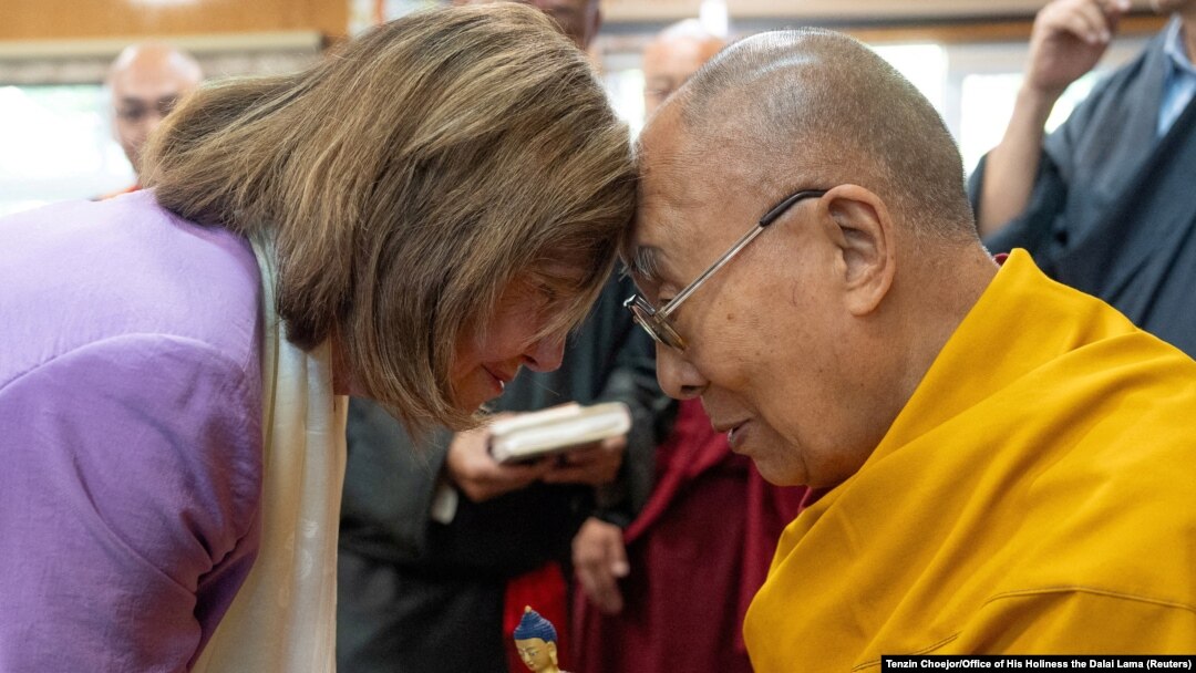 FILE - Tibetan spiritual leader, the Dalai Lama, exchanges greetings with former U.S. House Speaker Nancy Pelosi during a meeting at Dharamshala, Himachal Pradesh, India, June 19, 2024.