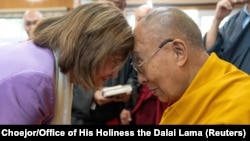 FILE - Tibetan spiritual leader, the Dalai Lama, exchanges greetings with former U.S. House Speaker Nancy Pelosi during a meeting at Dharamshala, Himachal Pradesh, India, June 19, 2024.
