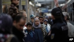 FILE - Refugees, mostly from Syria, arrive at the train station in Passau, Germany, Sept. 16, 2015. That year, Germany allowed hundreds of thousands of Syrian refugees to enter the country. Since then, Germany has become a global leader in the prosecution of Syrian war criminals.