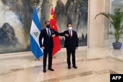 This screen grab made from video released by China Central Television on Dec. 10, 2021 shows Laureano Ortega Murillo, Nicaraguan President Ortega's son, greeting China's Vice Foreign Minister Ma Zhaoxu during a ceremony in Tianjin. (Photo by CCTV / AFP)