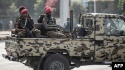 FILE - Security forces ride on the back of a pick-up truck in Addis Ababa, Ethiopia, June 5, 2022. Ethiopian authorities have arrested three journalists since introducing a new state of emergency in August.