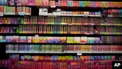 FILE - Disposable flavored e-cigarette devices are displayed for sale at Vapes N Smoke in Pinecrest, Florida, June 26, 2023. The French parliament is considering a ban on the single-use products.