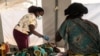 FILE - A health worker tends to a patient at a temporary cholera center in Lilongwe, Malawi, on Feb. 20, 2023. 