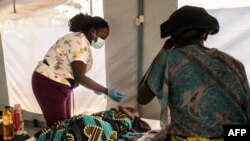 FILE - A health worker tends to a patient at a temporary cholera center in Lilongwe, Malawi, on Feb. 20, 2023. 