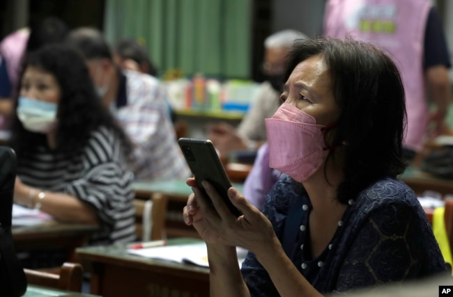 Students with Fake News Cleaner attend a class to learn how to use the LINE app in order to identify fake news, in Kaohsiung City, southern Taiwan, Thursday, March 16, 2023. (AP Photo/Chiang Ying-ying)