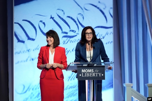 FILE - Moms for Liberty co-founders Tina Descovich, left, and Tiffany Justice, speak at the Moms for Liberty meeting in Philadelphia, Friday, June 30, 2023. (AP Photo/Matt Rourke)