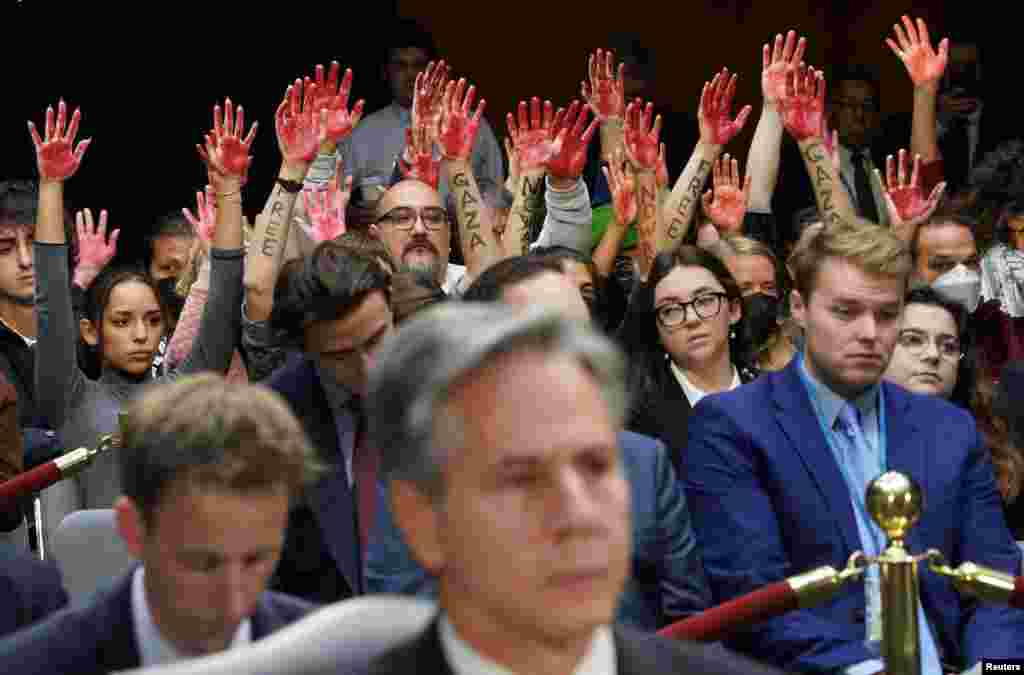 Anti-war protesters raise their &quot;bloody&quot; hands behind U.S. Secretary of State Antony Blinken during a Senate Appropriations Committee hearing on President Biden&#39;s $106 billion national security supplemental funding request to support Israel and Ukraine, as well as bolster border security,&nbsp;on Capitol Hill in Washington. REUTERS/Kevin Lamarque