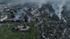 FILE - Smoke rises from buildings in this aerial view of Bakhmut, the site of the heaviest battles with the Russian troops in the Donetsk region, Ukraine, Apr. 26, 2023.