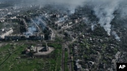 FILE - Smoke rises from buildings in this aerial view of Bakhmut, the site of the heaviest battles with the Russian troops in the Donetsk region, Ukraine, Apr. 26, 2023.