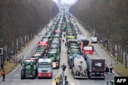 Tractors are lined up near the Brandenburg Gate in Berlin, Dec. 18, 2023, as German farmers demonstrate against the planned abolition of subsidies for agricultural diesel.
