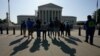 Visitors take photos in front of the U.S. Supreme Court, May 18, 2023.