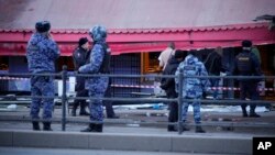 Police officers stand at the site of an explosion at a cafe in St. Petersburg, Russia, April 2, 2023.