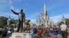 FILE - A statue of Walt Disney and Mickey Mouse stands in front of the Cinderella Castle at the Magic Kingdom at Walt Disney World in Lake Buena Vista, Florida, Jan. 9, 2019.
