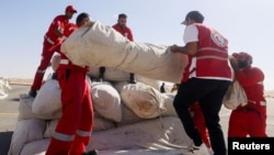 FILE -- Egyptian Red Crescent members coordinate aid for Gaza, after United Nations Secretary-General Antonio Guterres visited the Rafah border crossing between Egypt and the Gaza Strip, at Al Arish Airport, Egypt, Oct. 20, 2023