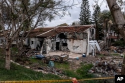 FILE - A battle-scarred home in Be'eri, an Israeli communal farm on the Gaza border, is seen on Jan. 11, 2024. Hamas held more than a dozen hostages in the home when it overran southern Israel on Oct. 7.