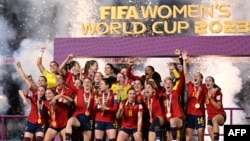 Spain's players celebrate with the trophy after winning the Australia and New Zealand 2023 Women's World Cup final football match between Spain and England at Stadium Australia in Sydney, Aug. 20, 2023.