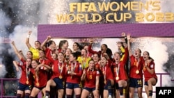 FILE - Spain's players celebrate with the trophy after defeating England to win the 2023 Women's World Cup final in Sydney, Aug. 20, 2023.
