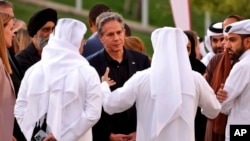 FILE - U.S. Secretary of State Antony Blinken listens to officials at Education City in Doha, Qatar, Nov. 21, 2022. Qatar's working relationships with traditional U.S. adversaries have made it an invaluable partner for the U.S. and others in the West. 