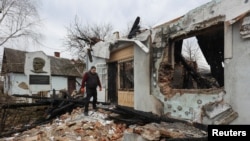 A man stands next to the museum dedicated to Roman Shukhevych, leader of the Ukrainian Insurgent Army (UPA), which was destroyed by a Russian drone strike, amid Russia's attack on Ukraine, in Lviv, Ukraine, Jan. 1, 2024. 