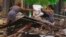 Residents recover belongings from the debris of their collapsed homes after an earthquake shook Machala, Ecuador, March 18, 2023.