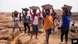Women work at an Illegal tin mining site in Jos, Nigeria, April 3, 2024.
