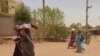 People walk along a street in southern Khartoum on May 20, 2023. Sudan's warring factions signed an agreement late on Saturday for a seven-day cease-fire.