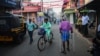 FILE - An elderly man walks through a street in the historic ward of Mattancherry, in Kochi, Kerala state, India, March 6, 2023. 