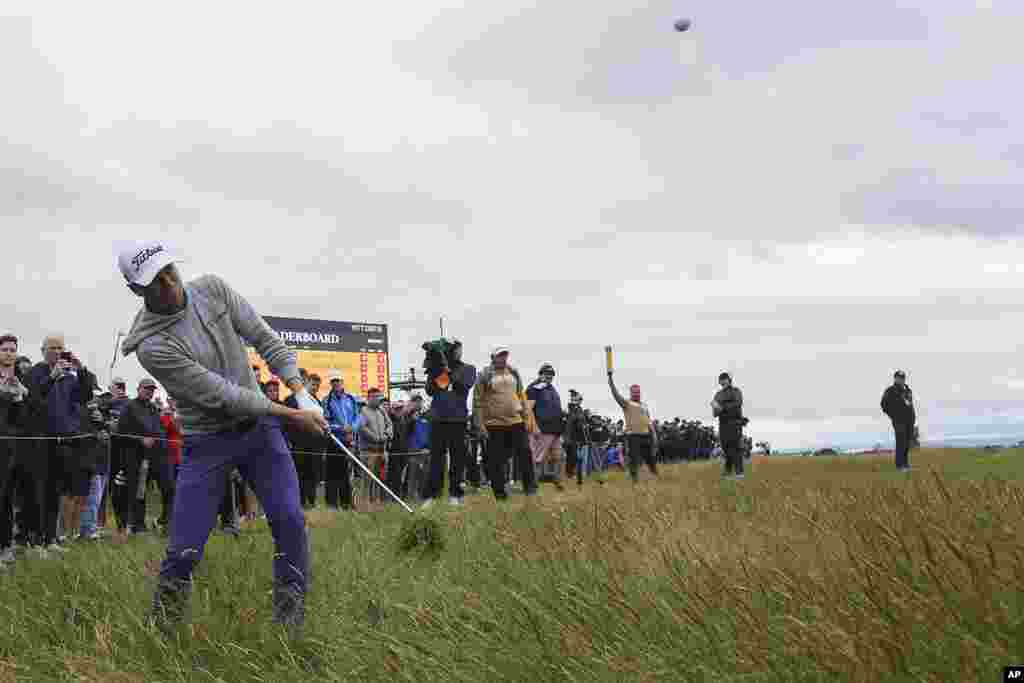 Justin Thomas of the United States plays from the rough on the 16th hole during his opening round of the British Open Golf Championships at Royal Troon golf club in Troon, Scotland.