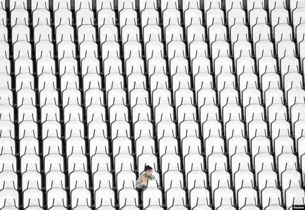 A fan in the stands is seen seating among empty seats before the soccer match between Juventus and Salernitana at the Allianz Stadium, Turin, Italy.