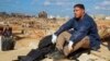 A volunteer sits on the rubble of a building in a flash flood-damaged area in Derna, Libya, on Sept. 14, 2023.