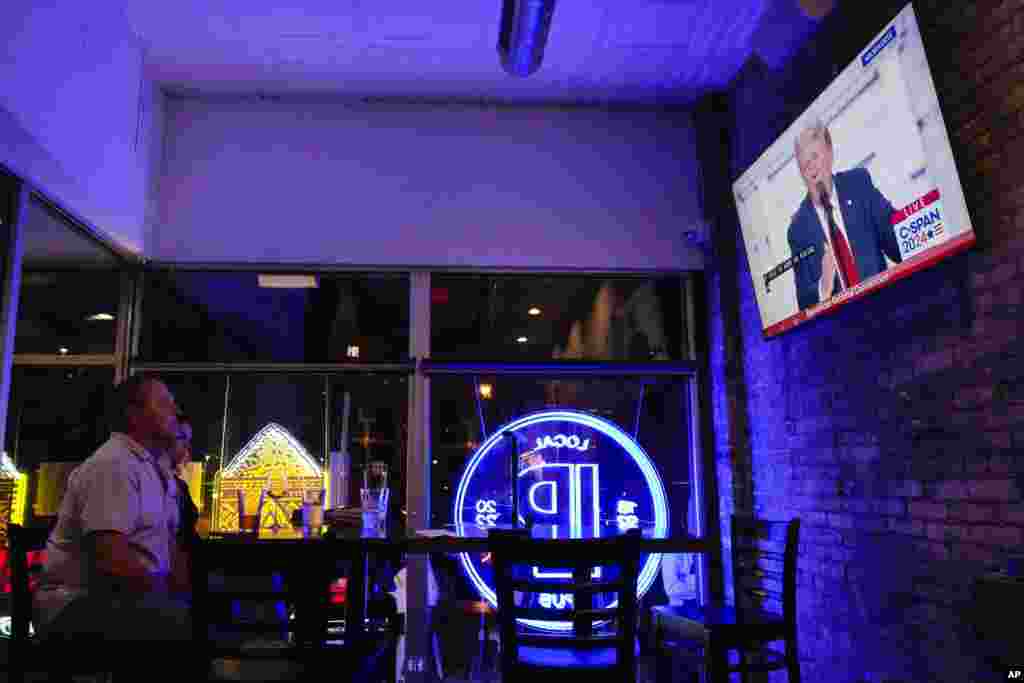 Jim and Tamara Hamilton of Wisconsin watch former President Donald Trump speak, outside the Fiserv Forum during the final day of the 2024 Republican National Convention, July 18, 2024, in Milwaukee.