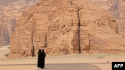 FILE - Women take pictures in the ruins of Al-Ula, a UNESCO World Heritage site in northwestern Saudi Arabia, on Feb. 19, 2023. 