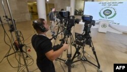 FILE - Cameramen make final preparations at the media hub of the convention center slated to host the Arab League Heads of State summit, in Algiers, on October 30, 2022.