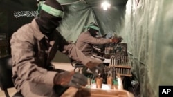 This image from video posted by Hamas on Dec. 20, 2023, purports to show Hamas militants using machining equipment to make their own domestic copies of the AM-50 Sayyad, an Iranian-made a sniper rifle.