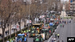 Farmers drive their tractors during a protest organised by 'Union de Uniones' union, in central Madrid, on March 17, 2024.