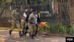 Police arrest a protester during the march to Parliament protest in Kampala, Uganda, July 23, 2024. (Halima Athumani/VOA)