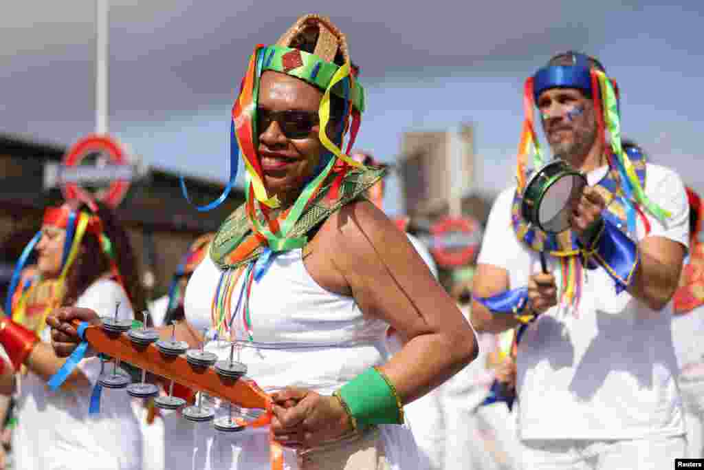 Revelers take part in the Notting Hill Carnival parade, in London.