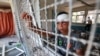 FILE - An injured boy stands by a window lattice in a destroyed classroom where people were sheltering at a school run by the U.N. Relief and Works Agency for Palestine Refugees that was previously hit by Israeli bombardment, in the Nuseirat camp in the Gaza Strip, June 7, 2024.